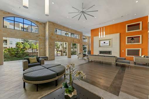 A modern living room with a fireplace and a large window.
