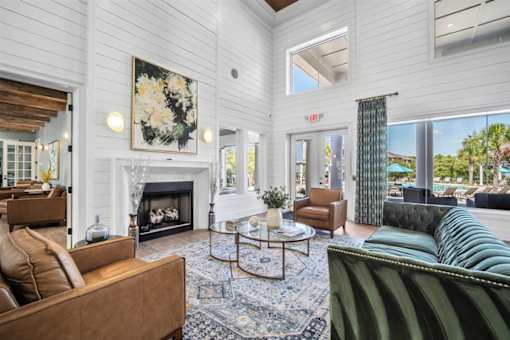 A living room with a fireplace and a painting on the wall.