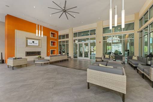 A spacious lobby with a fireplace and seating area.