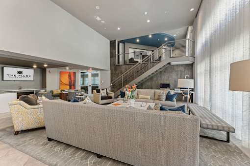 A living room with a grey sofa and a yellow chair.
