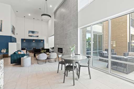 A modern living room with a dining table and chairs.