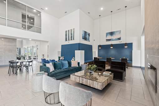 A modern living room with a blue accent wall and a coffee table in the center.