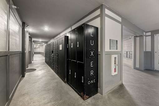 A hallway with a sign that says "LUXEER ONE" on the wall.