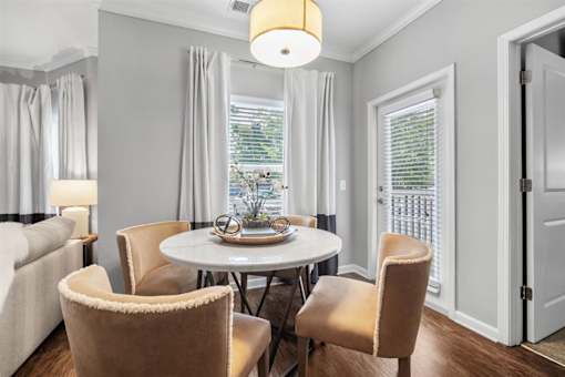 A dining room with a table and chairs.