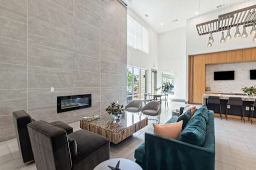 A modern living room with a fireplace and a green couch.