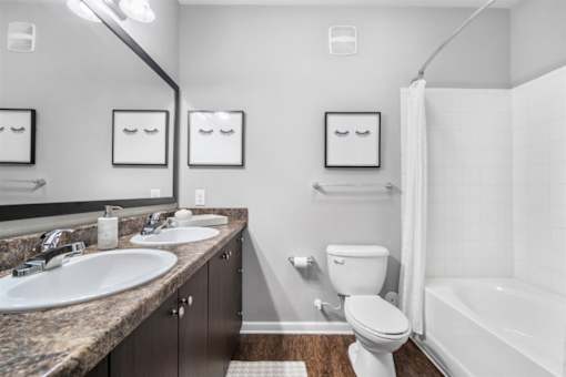 A bathroom with a sink, toilet, and bathtub.