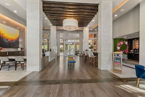 A long hallway with a wooden floor and a ceiling with a wooden beam.