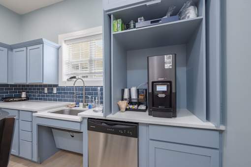 A kitchen with a dishwasher and a coffee machine.