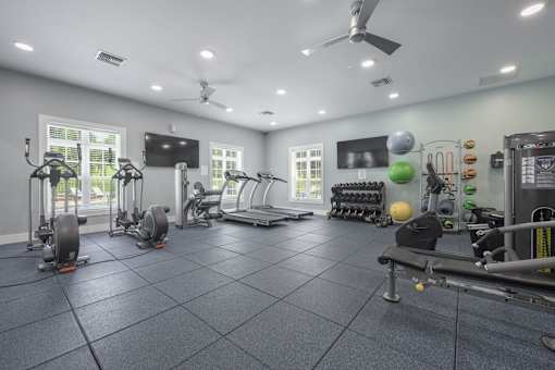 A spacious gym with a variety of exercise equipment.