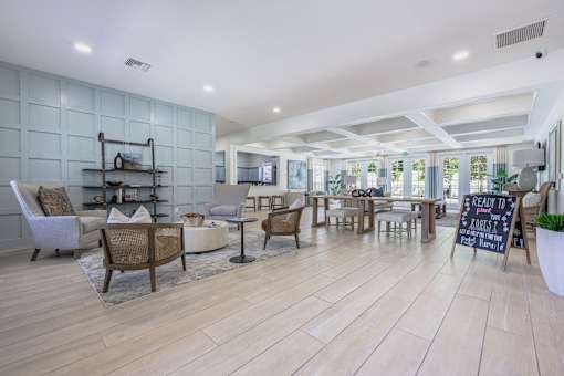 A room with wooden floors and a variety of seating options.