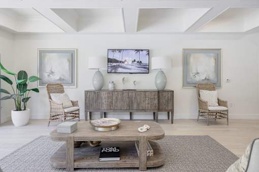 A living room with a wooden coffee table in the center.