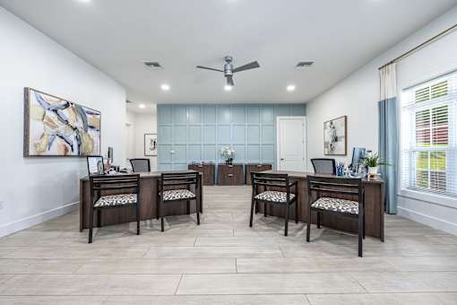 A room with a table and chairs set up for four people.