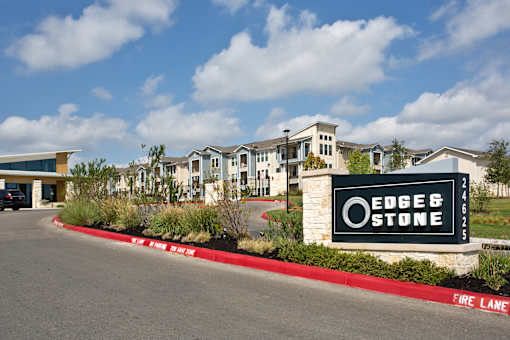 A sign for Edge & Stone in front of a building.