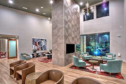A modern living room with a fireplace and a large window.