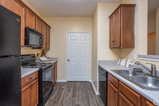 Kitchen with a Black Fridge at Mill Creek Run Apartments, Macon, GA, 31216