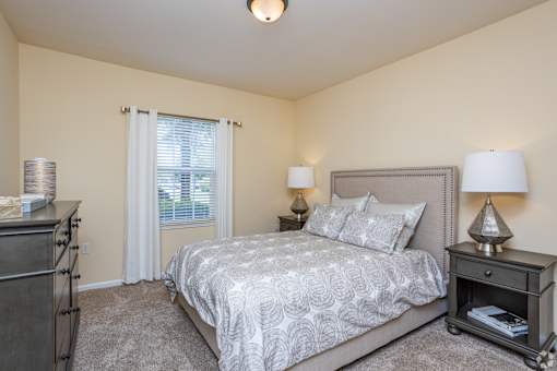 Bedroom with a Nightstand at Mill Creek Run Apartments, Georgia