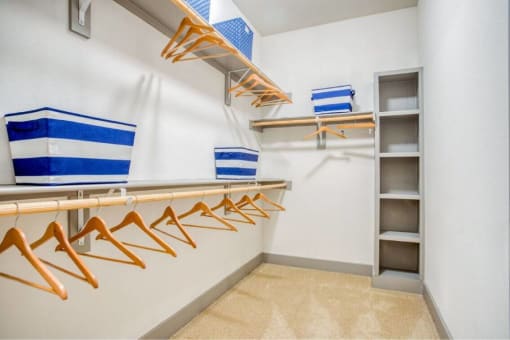 a walk in closet with a rack of hangers at The Mark, Texas, 78230