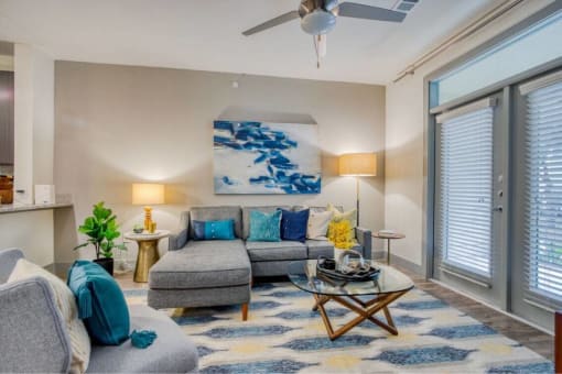 a living room with a couch and a ceiling fan at The Mark, San Antonio, TX