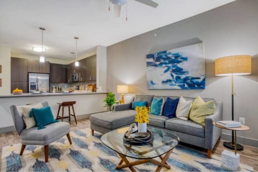 a living room with a couch and a table at The Mark, San Antonio Texas