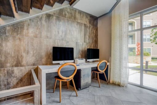 a home office with two computers on a desk with two chairs at The Mark, San Antonio, 78230
