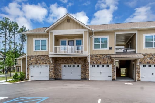 the front of a house with two garage doors at Sterling Creek, Richmond Hill, GA 31324
