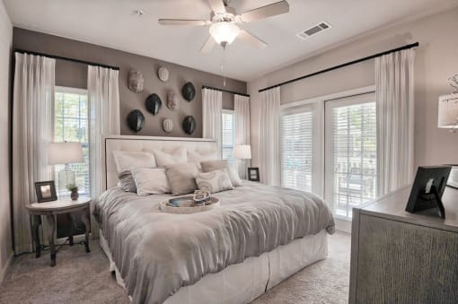 a bedroom with a bed and a ceiling fan at Sterling Creek, Georgia