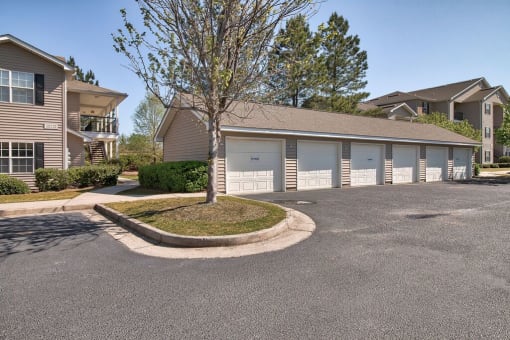 a building with garages and a street in front of it at Mill Creek Run, Macon, 31216