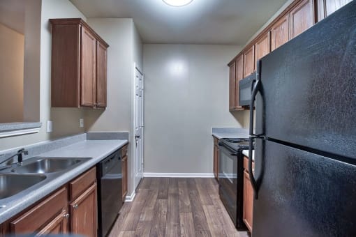 a kitchen with wood flooring and black appliances at Mill Creek Run, Georgia, 31216
