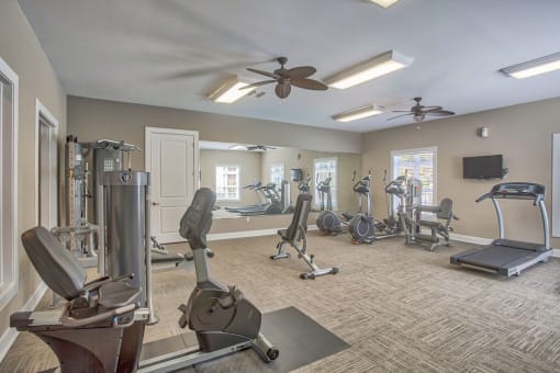 a gym with weights and a ceiling fan at Spring Creek Apartments, Crestview Florida