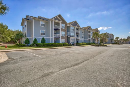 an empty parking lot in front of an apartment building at Spring Creek Apartments, Crestview, FL