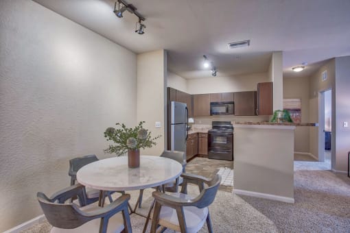 a dining room and kitchen with a table and chairs at Spring Creek Apartments, Crestview, FL 32536