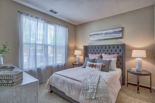 a bedroom with a bed and two windows at Spring Creek Apartments, Crestview