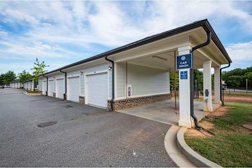 A car wash station with a blue sign above it at Waterleaf at Neely Ferry Apartments, South Carolina 29680