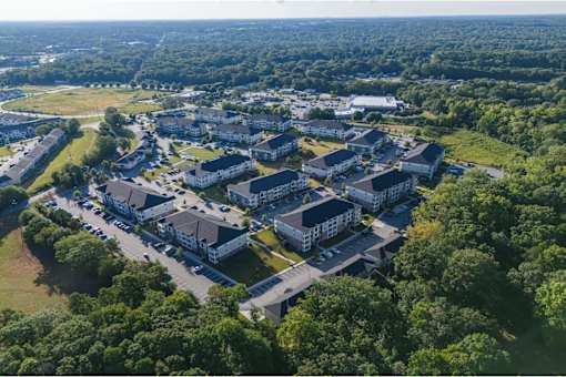 A bird's eye view of a large residential complex surrounded by trees at Waterleaf at Neely Ferry Apartments, Simpsonville