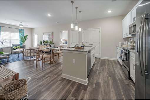 A modern kitchen with a wooden floor and stainless steel appliances at Waterleaf at Neely Ferry Apartments, Simpsonville, SC