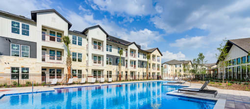 a large swimming pool in front of an apartment building at Legacy at Cibolo, Boerne, TX