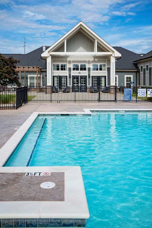 A pool in front of a house with a sign that says 3 feet at Waterleaf at Neely Ferry Apartments, Simpsonville