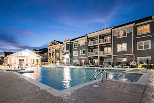 A large swimming pool is surrounded by apartment buildings at Waterleaf at Neely Ferry Apartments, Simpsonville, SC
