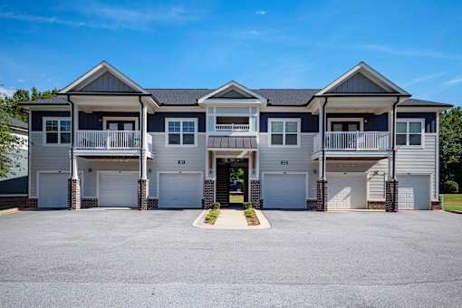 A row of houses with garages and driveways at Waterleaf at Neely Ferry Apartments, Simpsonville, 29680