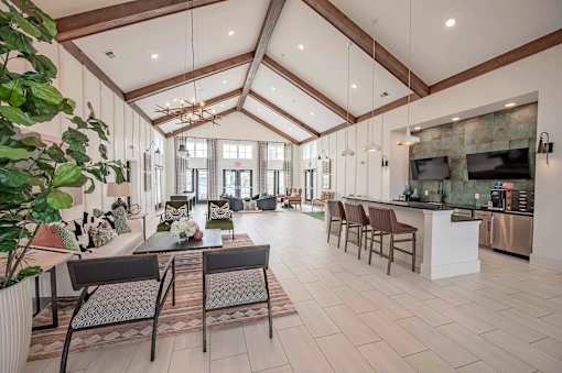 A spacious living room with a kitchen area in the background at Waterleaf at Neely Ferry Apartments, Simpsonville, 29680