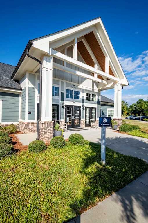 A building with a white and grey facade has a sign in front of it at Waterleaf at Neely Ferry Apartments, Simpsonville, SC 29680
