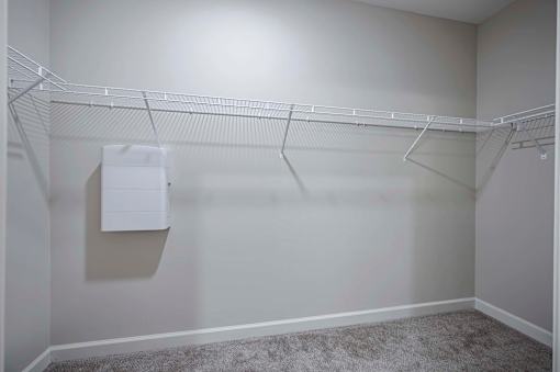 A white closet with a coat hanging at Waterleaf at Neely Ferry Apartments, Simpsonville, SC 29680