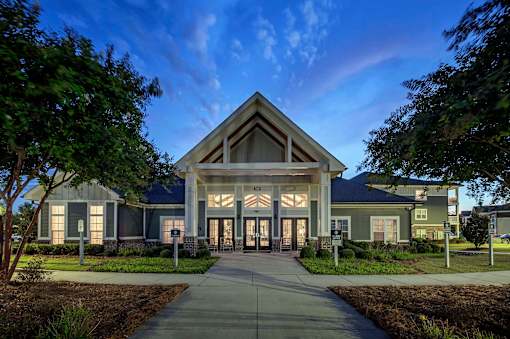 A modern building with a large entrance and glass windows at Waterleaf at Neely Ferry Apartments, Simpsonville, South Carolina