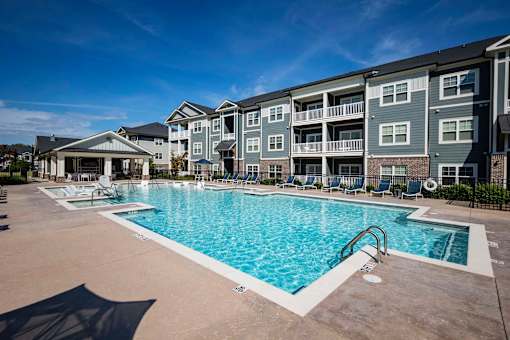 A large swimming pool in front of apartment buildings at Waterleaf at Neely Ferry Apartments, Simpsonville, SC