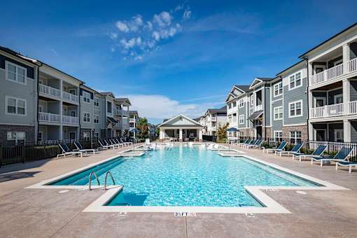 A large swimming pool in front of apartment buildings at Waterleaf at Neely Ferry Apartments, Simpsonville, SC 29680