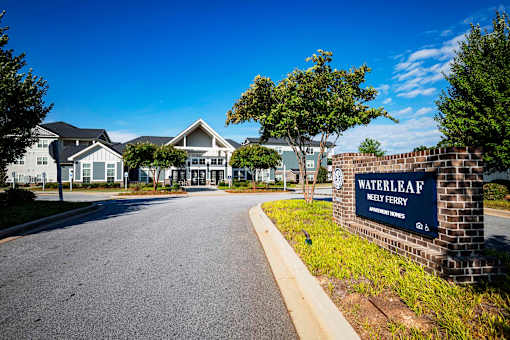 A sign for Waterleaf Homes stands in front of a row of houses at Waterleaf at Neely Ferry Apartments, Simpsonville, SC
