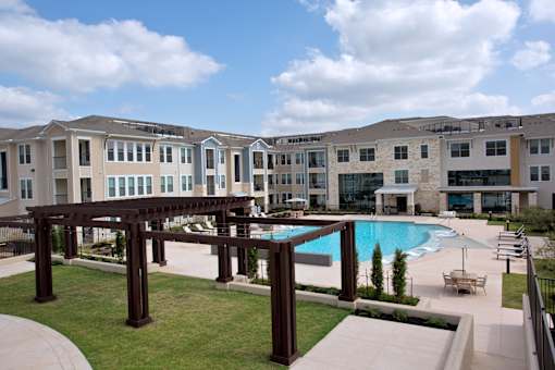 A large building with a pool in front.