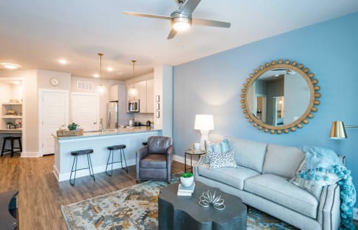 a living room with a couch and a table at Bellary Flats Apartments, Summerville , SC