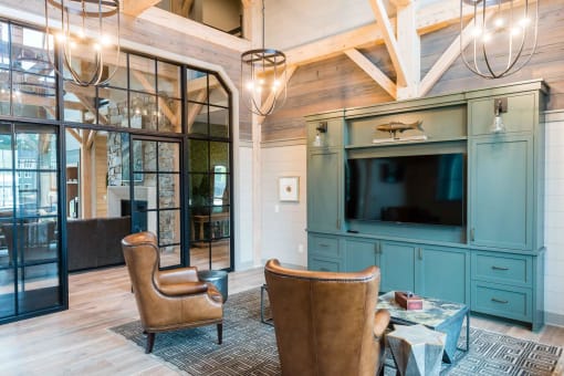 a living room with chairs and a tv at Bellary Flats Apartments, South Carolina