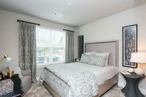a bedroom with a bed and a window at Bellary Flats Apartments, Summerville , 29486